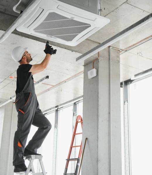 Happy Male Technician Repairing Air Conditioner Happy Male Technician Repairing Air Conditioner.